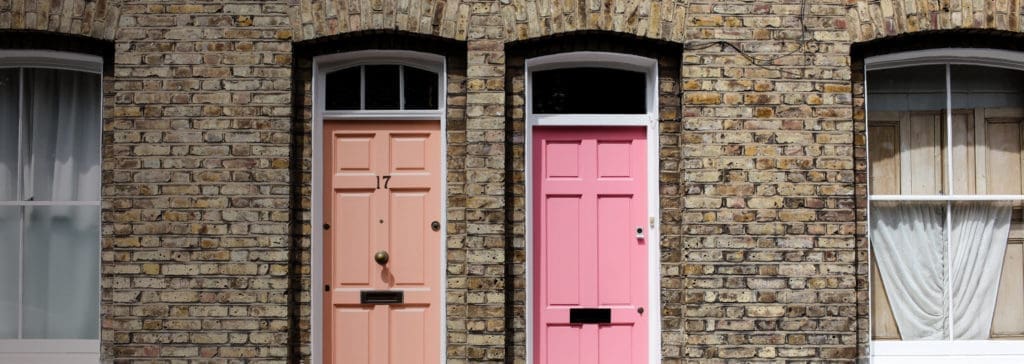 orange and pink front doors next to each other