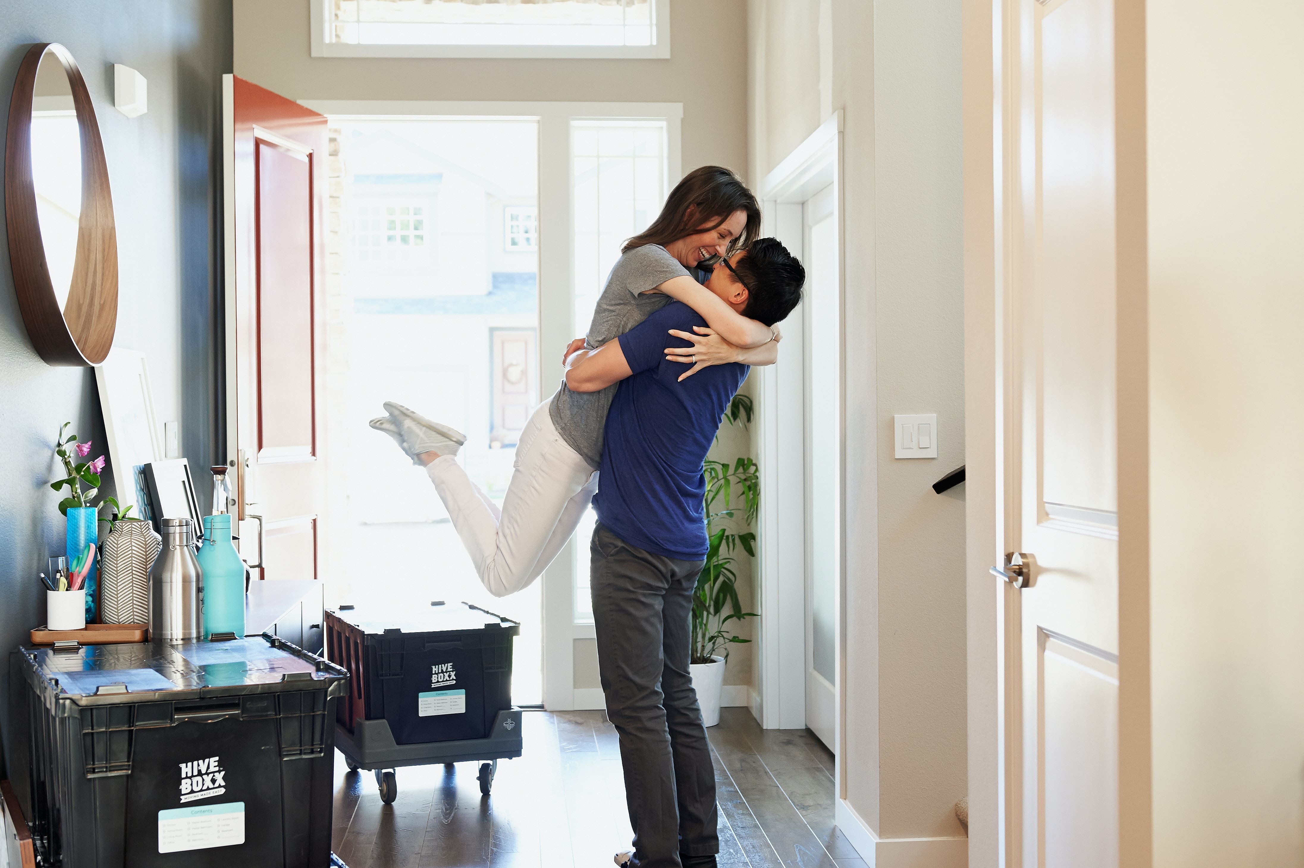 man lifting up a woman in a doorway