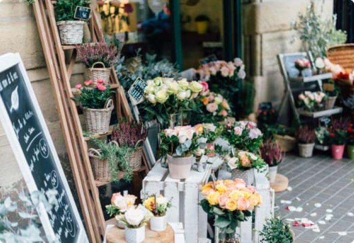 Commercial Loans Explained | The exterior of a flower shop with many pots of flowers and price signs