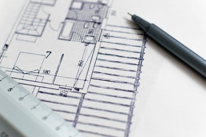 pen and ruler on house blueprint