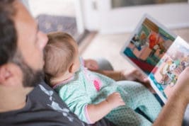 Father reading book with baby